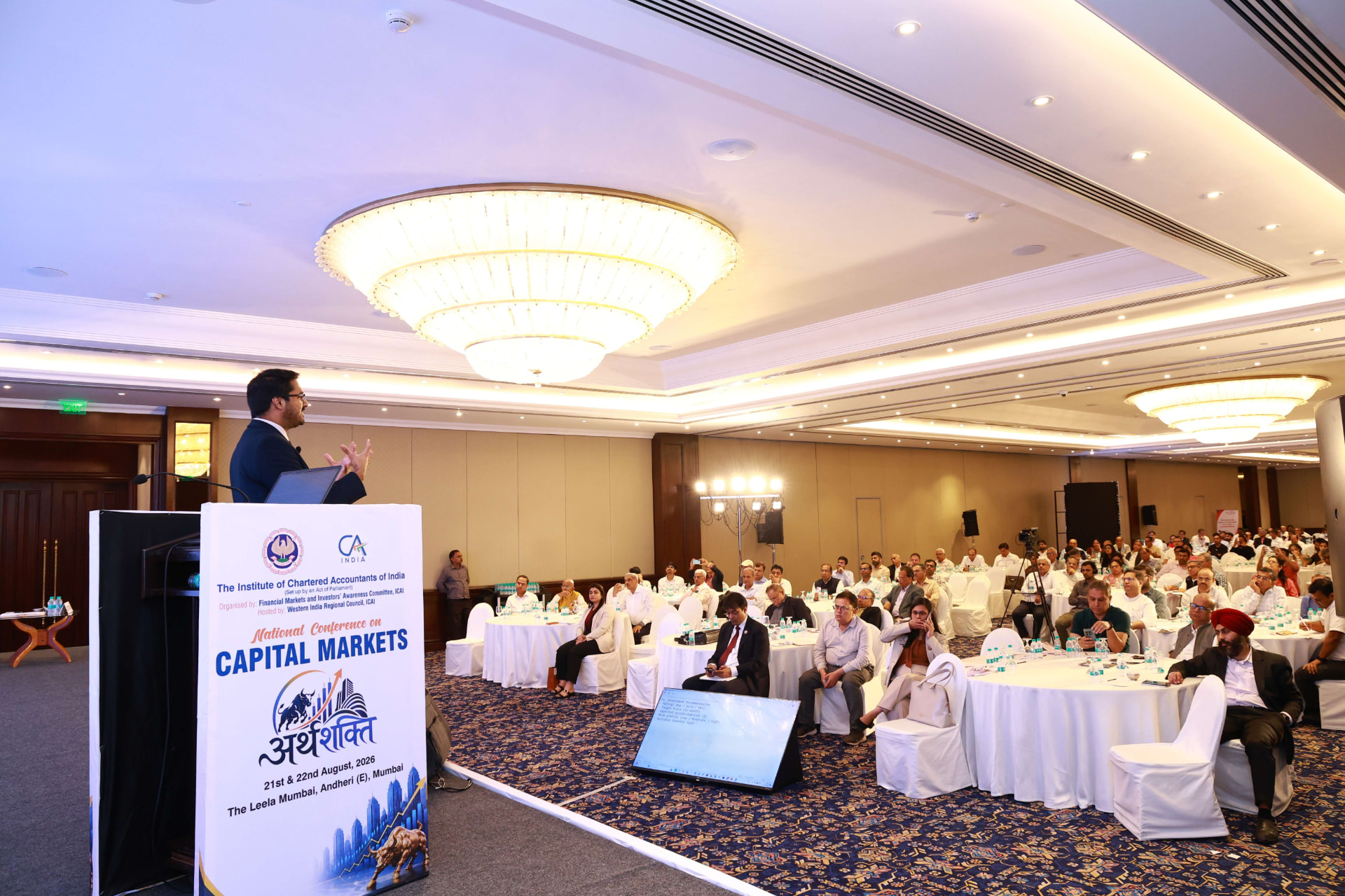 CA Dhaval Kodilkar speaking from the ICAI podium at The Leela Mumbai