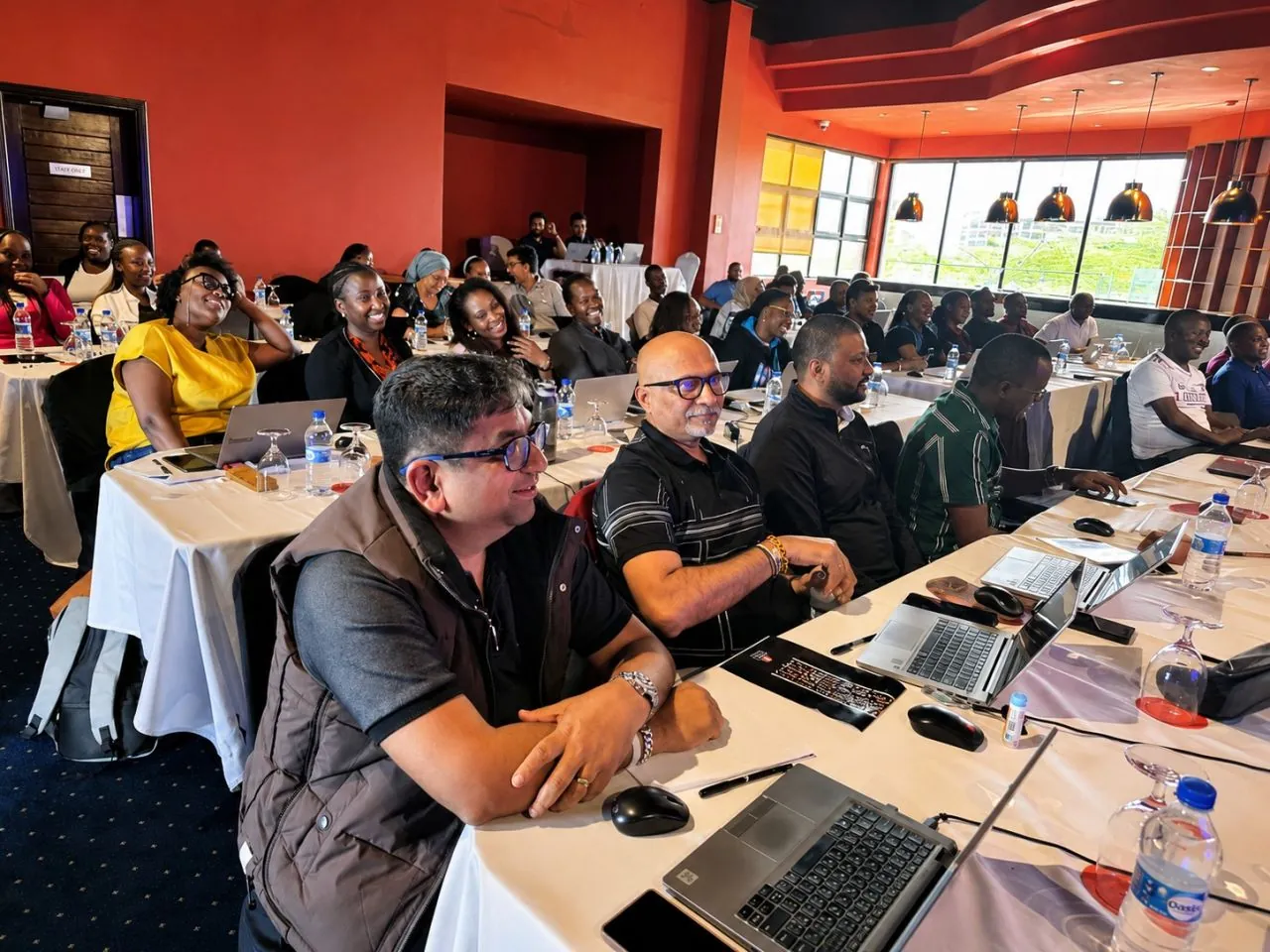 Copy Cat Group professionals working on laptops during a hands-on AI training session in Nairobi